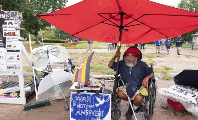 Philipos Melaku-Bello talks to people during Peace Vigil in Lafayette Park across from the White House in Washington, Sunday, Sept. 7, 2025. (AP Photo/Jose Luis Magana)