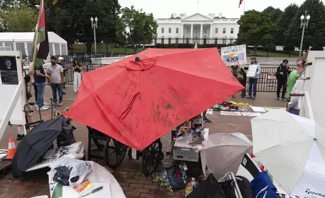 Demonstrators are seen during a Peace Vigil in Lafayette Park across from the White House in Washington, Sunday, Sept. 7, 2025. (AP Photo/Jose Luis Magana)