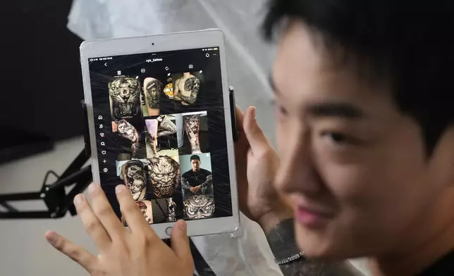Tattoo artist Song Jaemin speaks during an interview with The Associated Press at his studio in Goyang, South Korea, Thursday, Sept. 18, 2025. (AP Photo/Ahn Young-joon)