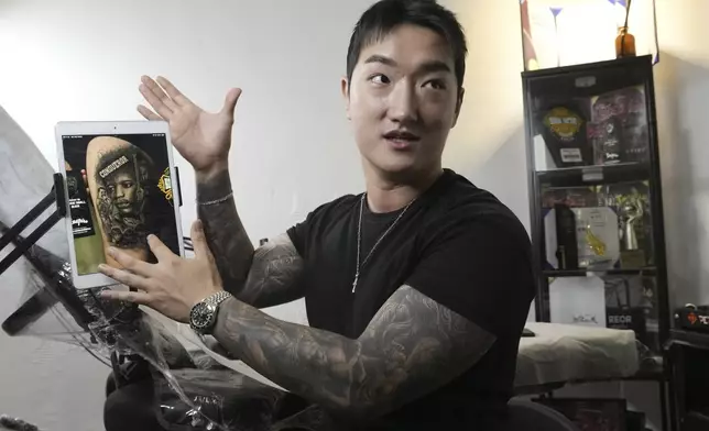 Tattoo artist Song Jaemin speaks during an interview with The Associated Press at his studio in Goyang, South Korea, Thursday, Sept. 18, 2025. (AP Photo/Ahn Young-joon)