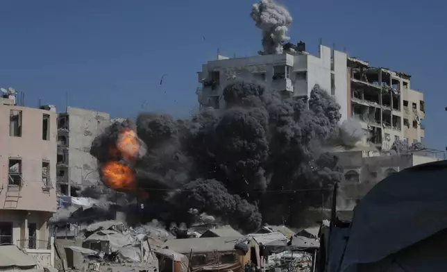 Smoke and flames rise after an Israeli military strike on a building in Gaza City, Friday, Sept. 12, 2025. (AP Photo/Yousef Al Zanoun)