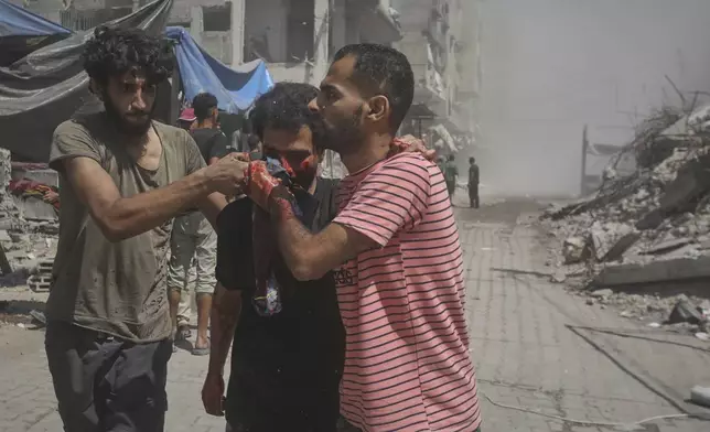 Palestinians evacuate a man who was injured in an Israeli military strike on a building in Gaza City, Saturday, Sept. 13, 2025. (AP Photo/Yousef Al Zanoun)