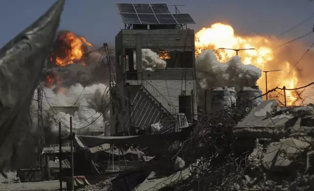 Smoke and flames rise after an Israeli military strike on a building in Gaza City, Saturday, Sept. 13, 2025. (AP Photo/Yousef Al Zanoun)