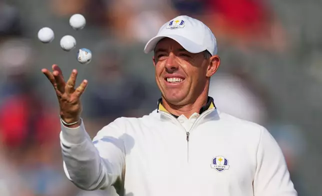 Europe's Rory McIlroy, of Northern Ireland, tosses balls in the air during a practice round for the Ryder Cup golf tournament, Tuesday, Sept. 23, 2025, in Farmingdale, N.Y., at Bethpage State Park's Black Course. (AP Photo/Matt Slocum)
