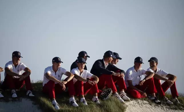 The USA team players watch from the 17th green as they play the Great Britain and Ireland team during Walker Cup golf matches at Cypress Point Club, Saturday, Sept. 6, 2025, in Pebble Beach, Calif. (AP Photo/Thien-An Truong)