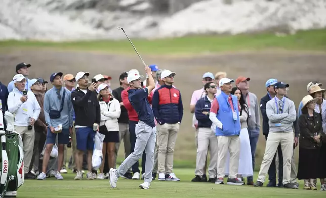 The Great Britain and Ireland team's Connor Graham hits from the 13th tee during Walker Cup golf matches against the USA team at Cypress Point Club on Saturday, Sept. 6, 2025, in Pebble Beach, Calif. (AP Photo/Thien-An Truong)