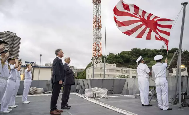 Australia's Defence Minister Richard Marles, centre left, and Japan's Defence Minister Gen Nakatani, centre right, take part in a ceremony ahead of a joint press announcement aboard the Japan Maritime Self-Defense Force (JMSDF) Mogami-class stealth frigate JS Mikuma at the JMSDF naval base in Yokosuka, Japan, Friday Sept. 5, 2025. (Yuichi Yamazaki/Pool Photo via AP)