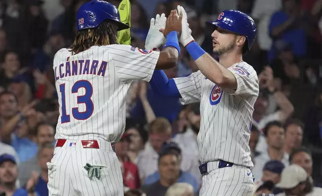 Chicago Cubs' Kyle Tucker, right, celebrates with Kevin Alcántara after hitting a three-run home run during the third inning of a baseball game against the Atlanta Braves in Chicago, Tuesday, Sept. 2, 2025. (AP Photo/Nam Y. Huh)