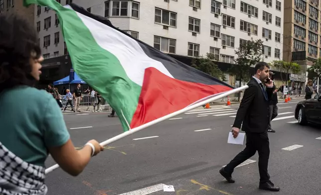 People protest the ongoing Israel-Palestine war outside the United Nations Headquarters during the 80th session of the UN General Assembly's discussion on a two-state solution, Monday, Sept. 22, 2025, in New York. (AP Photo/Angelina Katsanis)