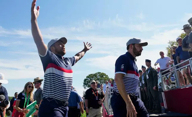 United States' Xander Schauffele and Patrick Cantlay celebrate their match win on the 18th hole at Bethpage Black golf course during the Ryder Cup golf tournament, Friday, Sept. 26, 2025, in Farmingdale, N.Y. (AP Photo/Robert Bukaty)