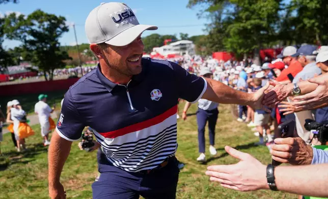 United States' Bryson DeChambeau greets fans on the second hole at Bethpage Black golf course during the Ryder Cup golf tournament, Friday, Sept. 26, 2025, in Farmingdale, N.Y. (AP Photo/Lindsey Wasson)