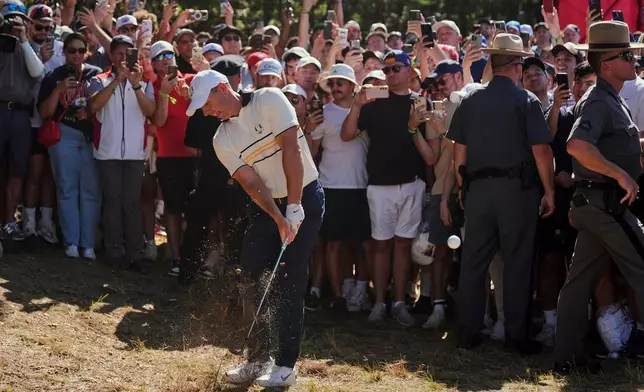 Europe's Rory McIlroy hits from the rough on the seventh hole during their singles match on the Bethpage Black golf course at the Ryder Cup golf tournament, Sunday, Sept. 28, 2025, in Farmingdale, N.Y. (AP Photo/Seth Wenig)
