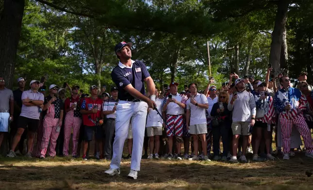 United States' Bryson DeChambeau hits from the rough on the 13th hole at Bethpage Black golf course during the Ryder Cup golf tournament, Saturday, Sept. 27, 2025, in Farmingdale, N.Y. (AP Photo/Matt Slocum)