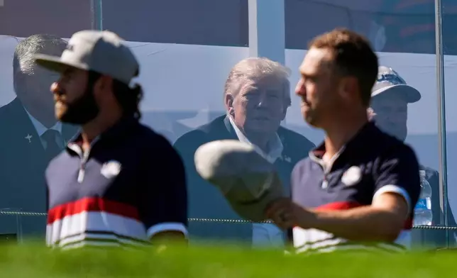President Donald Trump watches as United States' Cameron Young and Justin Thomas arrive at the first tee at Bethpage Black golf course during the Ryder Cup golf tournament, Friday, Sept. 26, 2025, in Farmingdale, N.Y. (AP Photo/Robert Bukaty)