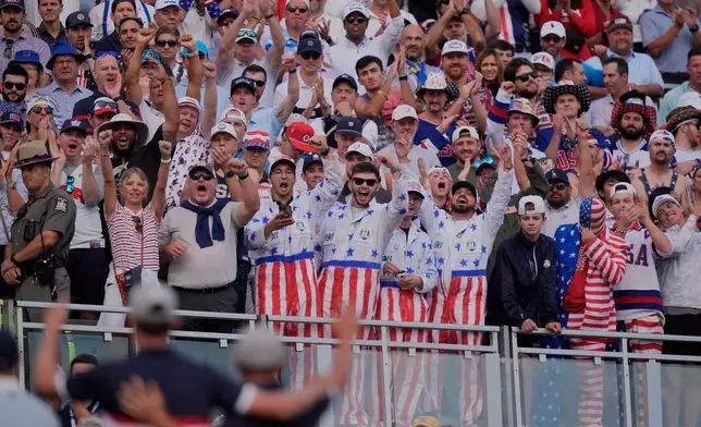 Fans cheer on the first hole at Bethpage Black golf course during the Ryder Cup golf tournament, Friday, Sept. 26, 2025, in Farmingdale, N.Y. (AP Photo/Robert Bukaty)
