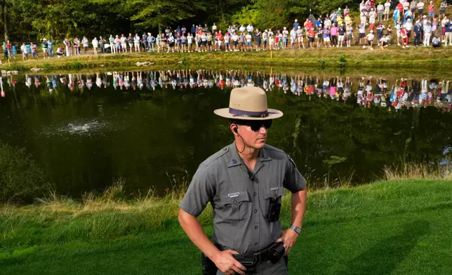 A New York Park Police officer watches on the eighth hole at Bethpage Black golf course during the Ryder Cup golf tournament, Friday, Sept. 26, 2025, in Farmingdale, N.Y. (AP Photo/Robert Bukaty)