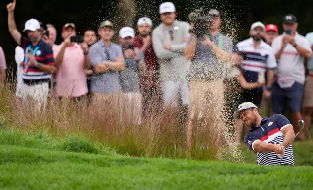 United States' Xander Schauffele hits from the bunker on the seventh hole at Bethpage Black golf course during the Ryder Cup golf tournament, Friday, Sept. 26, 2025, in Farmingdale, N.Y. (AP Photo/Robert Bukaty)