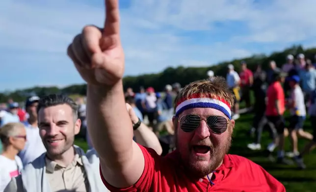 A fan cheers on the 12th hole at Bethpage Black golf course during the Ryder Cup golf tournament, Friday, Sept. 26, 2025, in Farmingdale, N.Y. (AP Photo/Seth Wenig)