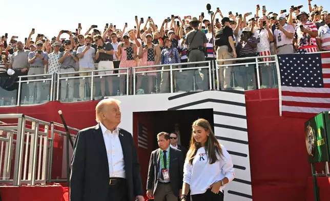 President Donald Trump, left, and his granddaughter Kai Trump, right, attend the Ryder Cup golf tournament at Bethpage Black Golf Course in Farmingdale, N.Y., Friday, Sept. 26, 2025. (Mandel Ngan/Pool Photo via AP)