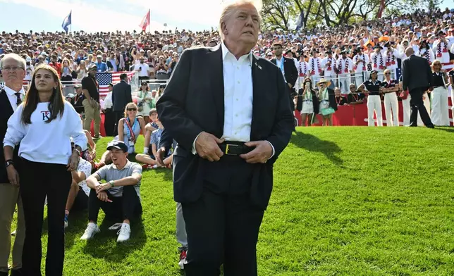 President Donald Trump and his granddaughter Kai Trump, second left, attend the Ryder Cup golf tournament at Bethpage Black Golf Course in Farmingdale, N.Y., Friday, Sept. 26, 2025. (Mandel Ngan/Pool Photo via AP)