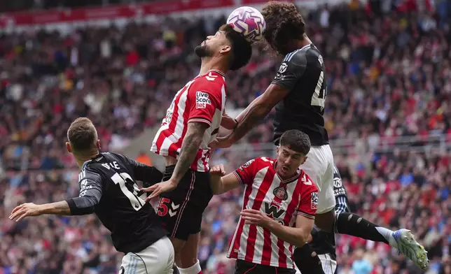 Sunderland's Omar Alderete and Aston Villa's Boubacar Kamara, right, in action during the English Premier League soccer match between Sunderland and Aston Villa at the Stadium of Light, in Sunderland, England, Sunday Sept. 21, 2025. (Owen Humphreys/PA via AP)