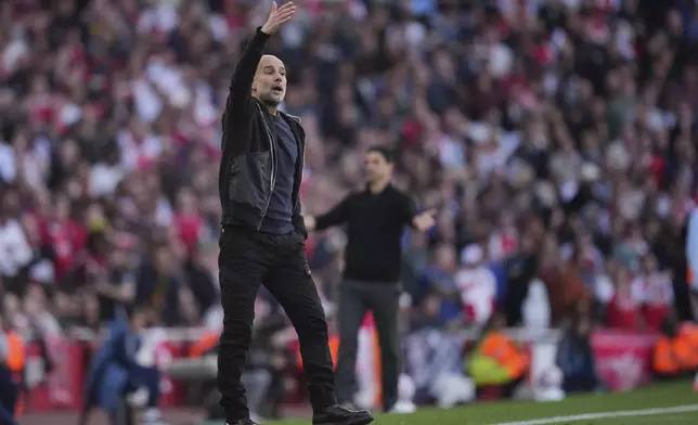 Manchester City's head coach Pep Guardiola gives instructions during the Premier League soccer match between Arsenal and Manchester City in London, Sunday, Sept. 21, 2025. (AP Photo/Kin Cheung)