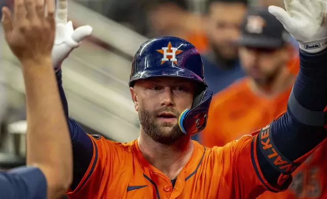 Houston Astros' Christian Walker (8) celebrates after scoring a run during the third inning of a baseball game against the Atlanta Braves, Saturday, Sept. 13, 2025, in Atlanta. (AP Photo/Erik Rank)