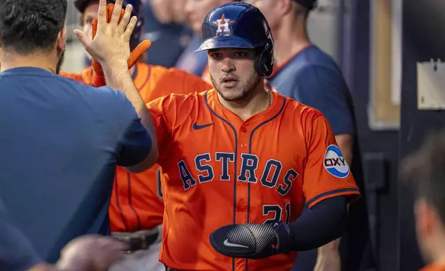 Houston Astros' Yainer Diaz (21) celebrates after scoring a run during the second inning of a baseball game against the Atlanta Braves, Saturday, Sept. 13, 2025, in Atlanta. (AP Photo/Erik Rank)