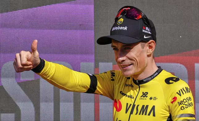 Danish rider Jonas Vingegaard, from Visma | Lease a Bike team celebrates at the podium after wining the ninth stage of La Vuelta from Alfaro to Valdezcaray, Spain, Sunday, Aug. 31, 2025. (AP Photo/Miguel Oses)