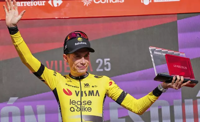 Danish rider Jonas Vingegaard, from Visma | Lease a Bike team celebrates at the podium after wining the ninth stage of La Vuelta from Alfaro to Valdezcaray, Spain, Sunday, Aug. 31, 2025. (AP Photo/Miguel Oses)