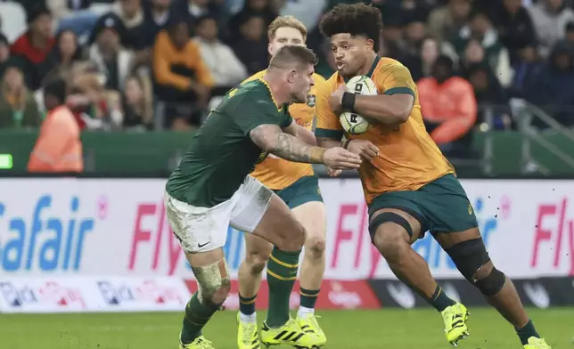 Australia's Rob Valetini, right, is challenged by South Africa's Malcolm Marx during a rugby championship test match between South Africa and Australia, at Cape Town stadium in Cape Town, South Africa, Saturday, Aug. 23, 2025. (AP Photo/Halden Krog)