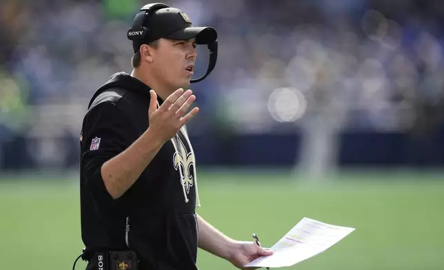 New Orleans Saints head coach Kellen Moore calls out from the sideline during the first half of an NFL football game against the Seattle Seahawks, Sunday, Sept. 21, 2025, in Seattle. (AP Photo/Stephen Brashear)