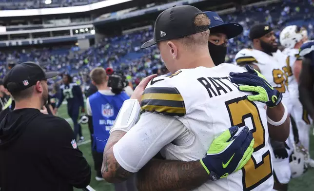 New Orleans Saints quarterback Spencer Rattler (2) greets Seattle Seahawks wide receiver Jaxon Smith-Njigba after an NFL football game, Sunday, Sept. 21, 2025, in Seattle. (AP Photo/Lindsey Wasson)