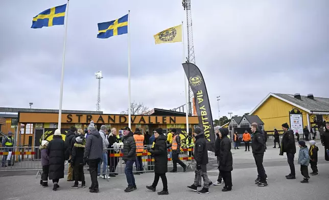 Fans arrive at the Strandvallen stadium ahead of the quarter-final soccer match of the Swedish Cup between Mjallby AIF and AIK at Strandvallen in Hallevik, Denmark, Saturday March 9, 2024. (Johan Nilsson /TT News Agency via AP)