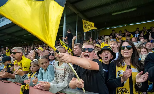 Mjallby supporters at the stand during the soccer match between Mjallby AIF and Halmstad BK at Strandvallen in Hallevik, Sweden, Saturday Aug. 30, 2025. (Johan Nilsson /TT News Agency via AP)