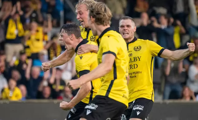 Mjallby AIF's Elliot Stroud celebrates with Herman Johansson, Alexander Johansson and Jacob Bergstrom after scoring his side's first goal of the game during the soccer match between Mjallby AIF and Halmstad BK at Strandvallen in Hallevik, Sweden, Saturday Aug. 30, 2025. (Johan Nilsson /TT News Agency via AP)