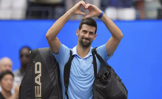 Novak Djokovic, of Serbia, acknowledges the crowd after losing to Carlos Alcaraz, of Spain, during the men's singles semifinals of the U.S. Open tennis championships, Friday, Sept. 5, 2025, in New York. (AP Photo/Seth Wenig)