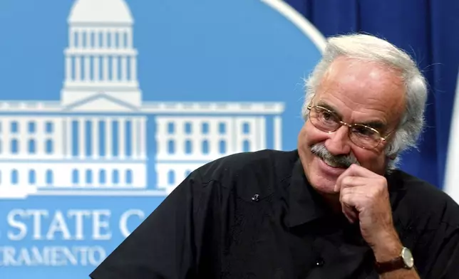 FILE - State Sen. President Pro Tem John Burton, D-San Francisco, smiles as he reminisces about his time in the Legislature during a Capitol news conference held in Sacramento, Calif., Tuesday, Aug. 31, 2004. (AP Photo/Rich Pedroncelli)