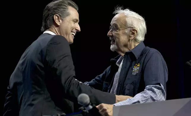 FILE - California gubernatorial candidate, Lt. Gov. Gavin Newsom, left, jokes with John Burton chairman of the California Democratic Party, before addressing the California Democratic Party Convention, Saturday, May 20, 2017, in Sacramento, Calif. (AP Photo/Rich Pedroncelli,File)
