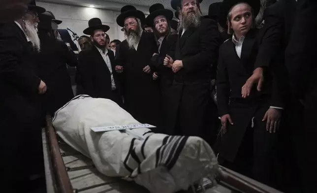 Mourners attend the funeral of Levi Yitzhak Pash, who was killed along with five other Israelis in a shooting attack by two Palestinian gunmen at a bus stop in Jerusalem Monday, Sept. 8, 2025. (AP Photo/Ariel Schalit)