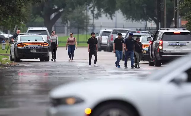 People who had appointments at a U.S. Immigration and Customs Enforcement office are turned away after a reported shooting in the facility in Dallas on Wednesday, Sept. 24, 2025. (AP Photo/Julio Cortez)