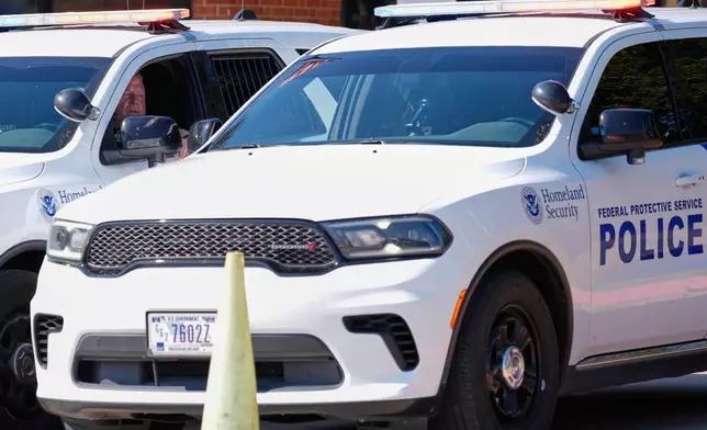 Homeland security personnel sit in their vehicles in front of the U.S. Immigration and Customs Enforcement office Thursday, Sept. 25, 2025, in Dallas. (AP Photo/Tony Gutierrez)