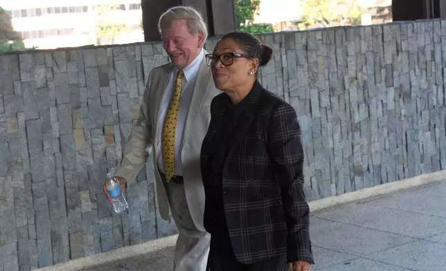 Shawn Holley, right, and Rusty Hardin, attorneys for the family of former baseball pitcher Tyler Skaggs, arrive during the trial for the wrongful death lawsuit accusing the Los Angeles Angels baseball team of being responsible for the 2019 drug overdose death of Skaggs Tuesday, Oct. 21, 2025, in Santa Ana, Calif. (AP Photo/Gregory Bull)