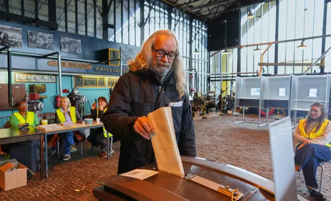 A man casts his ballot at the Kromhout shipyard museum, which is operating as a polling station, during general elections in Amsterdam, Netherlands, Wednesday, Oct. 29, 2025. (AP Photo/Peter Dejong)