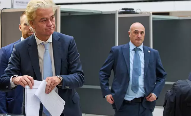 Far-right anti Islam lawmaker Geert Wilders, second left, casts his vote at a polling station during general elections in The Hague, Netherlands, Wednesday, Oct. 29, 2025. (AP Photo/Peter Dejong)