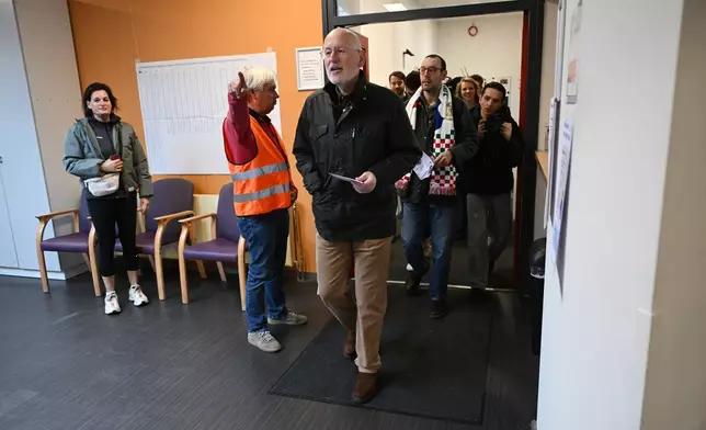 Frans Timmermans, of the center-left two party bloc of Labor Party and Green Left, center, arrives at a polling station during general elections in Maastricht, Netherlands, Wednesday, Oct. 29, 2025. (AP Photo/Ermindo Armino)