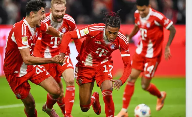 Bayern's Michael Olise, centre, celebrates with teammates after scoring his side's second goal during the Bundesliga soccer match between Bayern Munich and Borussia Dortmund in Munich, Germany, Saturday, Oct. 18, 2025. (AP Photo/Lennart Preiss)