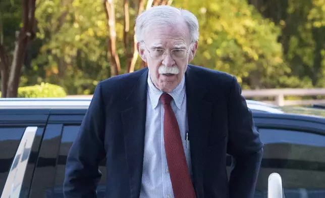 Former Trump administration national security adviser John Bolton, left, arrives for his arraignment at the Greenbelt Federal Courthouse in Greenbelt, Md., Friday, Oct. 17, 2025. (AP Photo/Rod Lamkey, Jr.)