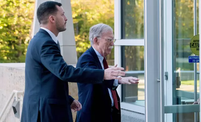 Former Trump administration national security adviser John Bolton, right, arrives for his arraignment at the Greenbelt Federal Courthouse in Greenbelt, Md., Friday, Oct. 17, 2025. (AP Photo/Rod Lamkey, Jr.)