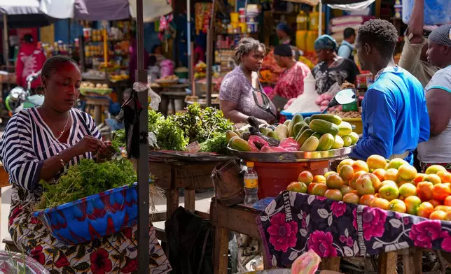 FILE - A vegetable seller sorts fresh produce at a market in Conakry, Guinea, Sept. 19, 2025 (AP Photo/Misper Apawu, File)